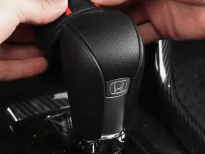 Black textured automatic shift knob cover installed in a car