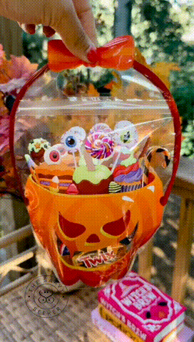 Halloween pumpkin treat bags filled with candy and party favors