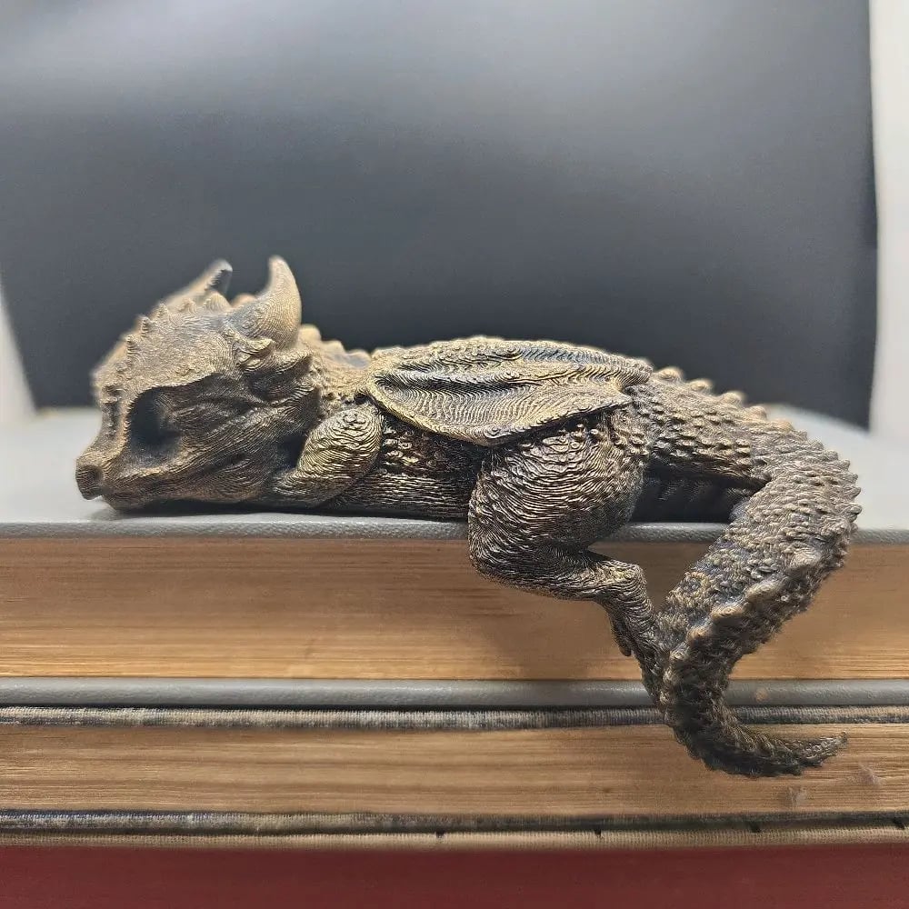 All four sleeping dragon colors displayed on vintage book stack