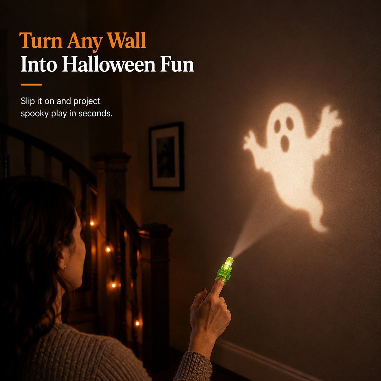 Green finger projector casting a Halloween ghost image onto an indoor wall Green finger projector casting a Halloween ghost image onto an indoor wall