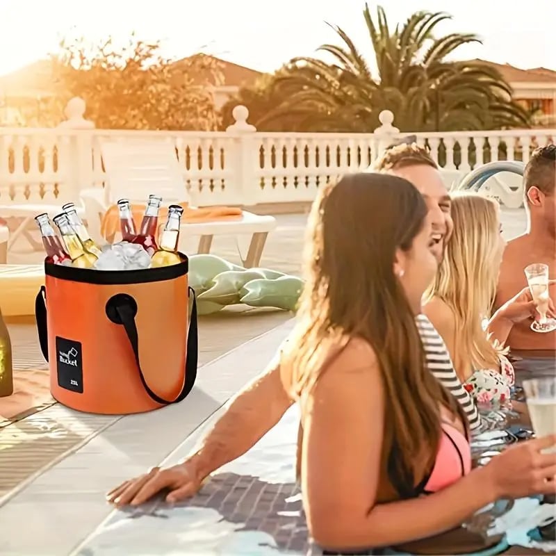Orange folding bucket holding ice and bottled drinks at an outdoor gathering