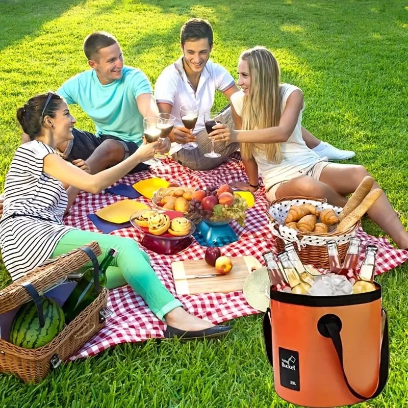Portable folding bucket holding ice and bottled drinks at an outdoor picnic