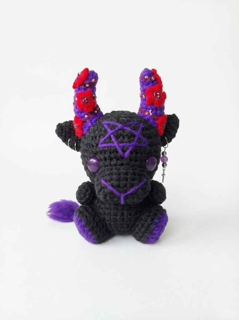 Front view of the demon plush with pentagram