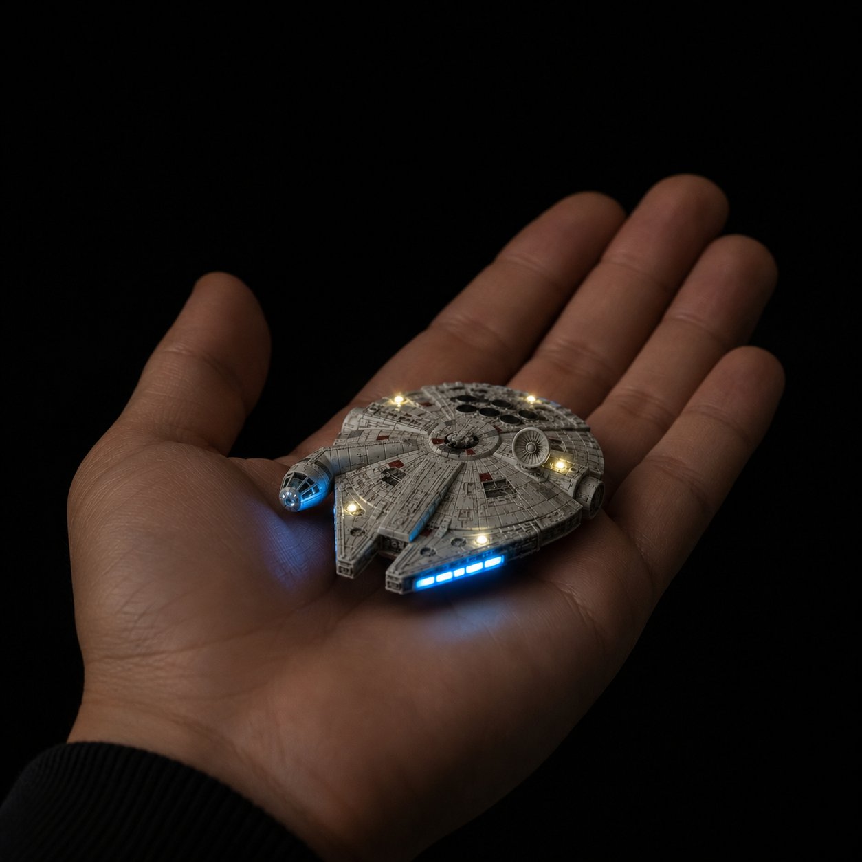 Millennium Falcon model with lighting effect in hand