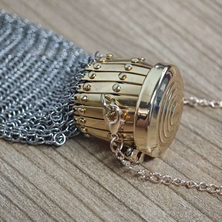 Two metal mesh coin purses showing silver and gold top details