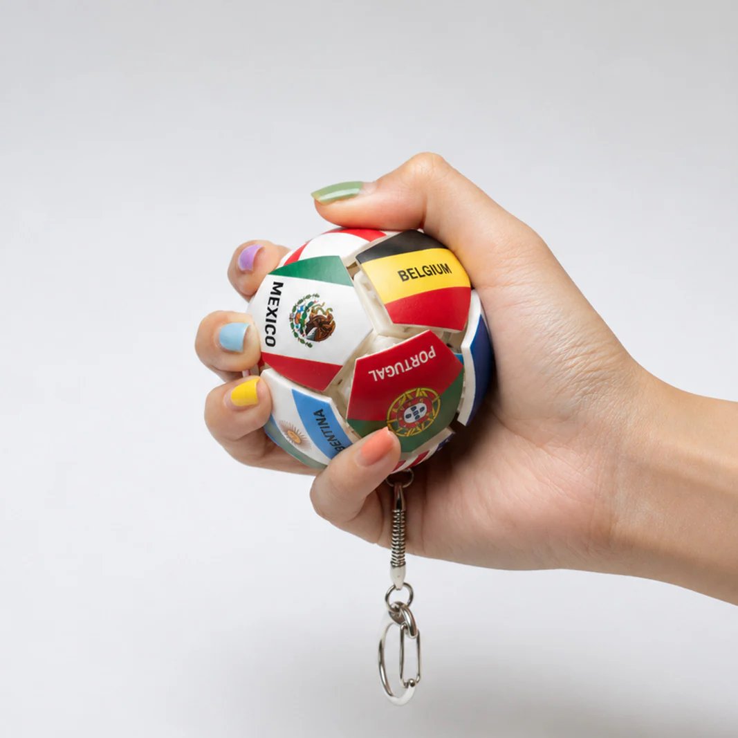 Hand holding football fidget keychain