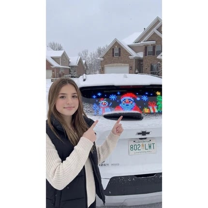 DrivePixel customer standing beside rear window display
