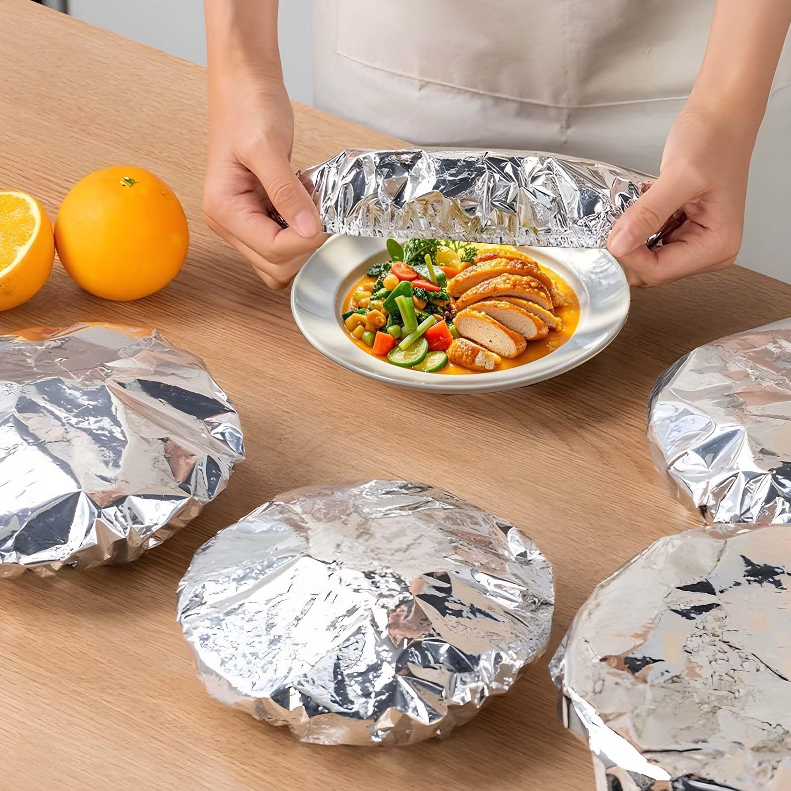 Sturdy foil food covers on table
