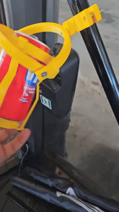 Gyroscopic anti-spill clamp-on cup holder in use