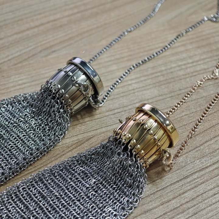 Close-up of vintage metal mesh coin purse held in hand
